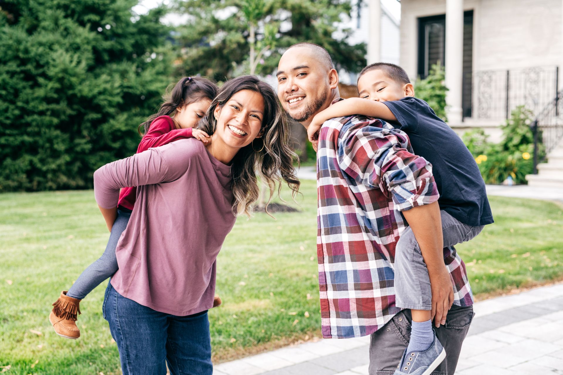 2 a family playing in front of their house
